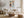 Copper Shore abstract wall art in a light wood frame above a cream sofa.