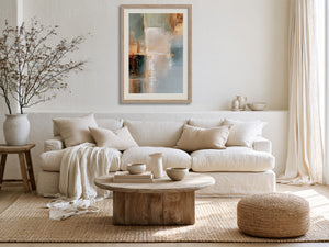 Copper Shore abstract wall art in a light wood frame above a cream sofa.