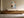 Copper Shore in a light wood frame above a low wooden sideboard.