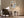 Framed abstract wall art above an upholstered armchair beside a floor lamp.
