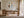 Copper Shore framed above a wooden desk near tall windows and sheer curtains.
