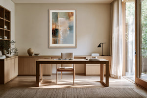 Copper Shore framed above a wooden desk near tall windows and sheer curtains.