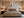 Framed Copper Shore abstract art centered above a bed between two bedside tables.