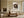 Framed bird nest artwork with three speckled eggs above a cream sofa and wooden coffee table.