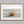 Dune Stillness shown in an oak frame with a white border or mount.