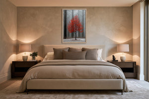 Light wood-framed red-leaved tree artwork centered above a bed between matching nightstands and lamps.