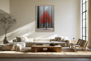 Light wood-framed red-leaved tree artwork above a sectional sofa and wooden coffee table.