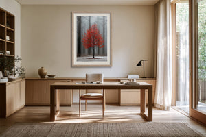 Light wood-framed red-leaved tree artwork displayed above a wooden desk with chair and lamp.