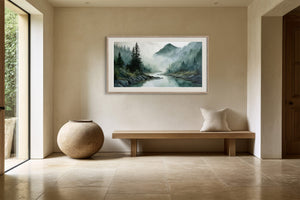 Framed mountain river watercolor above a simple wood bench beside a large round vessel.