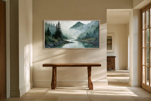 Framed misty river landscape watercolor above a rustic wood console in a sunlit hallway.