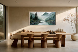 Framed mountain river watercolor displayed above a long wooden dining table with sculptural chairs.