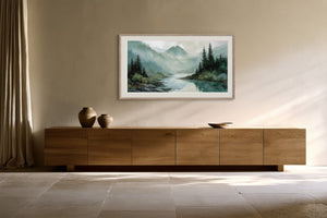 Framed mountain river watercolor hanging above a low wooden sideboard with ceramic vessels.