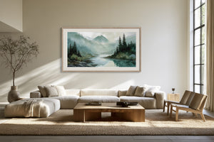 Framed mountain river watercolor above a cream sectional sofa and wooden coffee table.