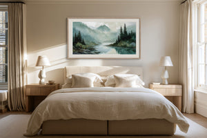 Framed mountain river watercolor centered above a bed with white linens and bedside lamps.