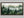 Greenwood Haze shown in a walnut frame without a border or mount.